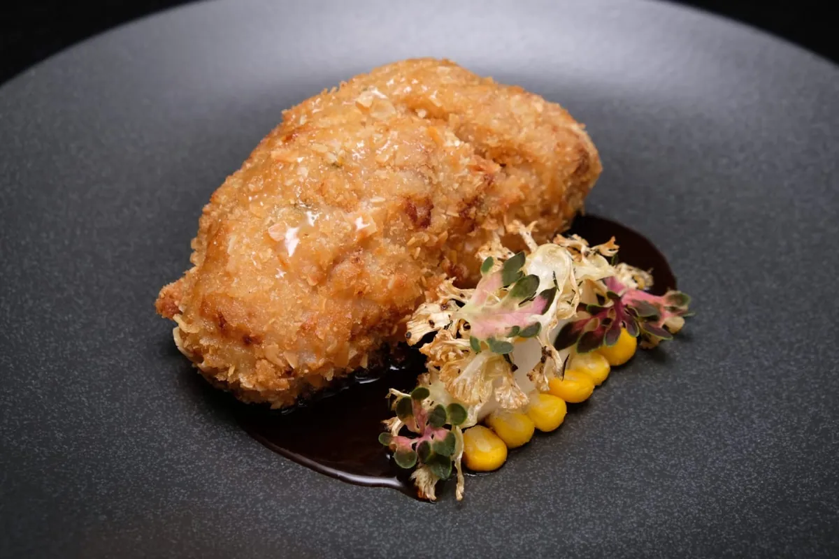 Crumbed main with roasted cauliflower, corn and dark jus