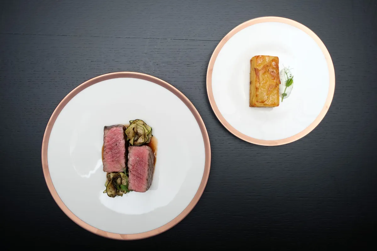Beef with zucchini ribbons and jus, and a potato pavé